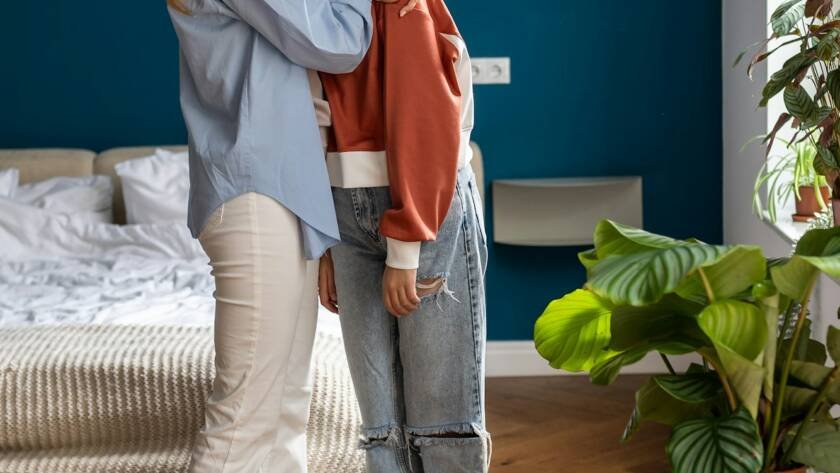 Loving mother comforting hugging unhappy teenage daughter, mom supporting depressed teen girl child